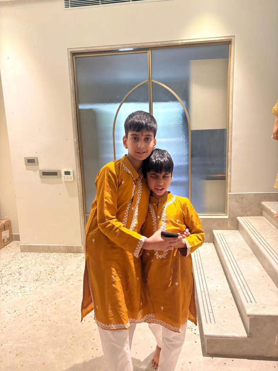 Two brothers in matching mustard kurta sets