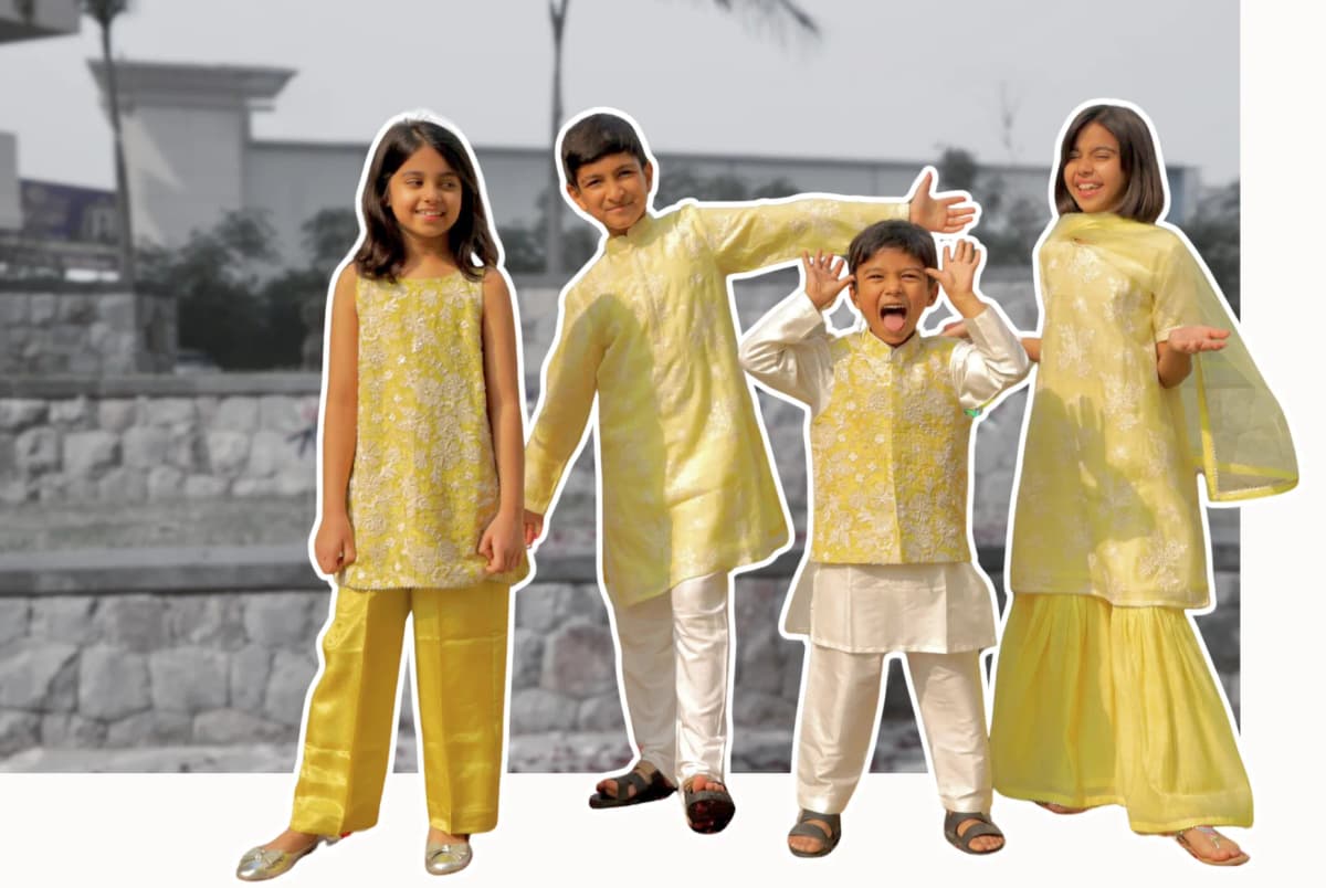 Four children in yellow embroidered Taber Tikri festive outfits